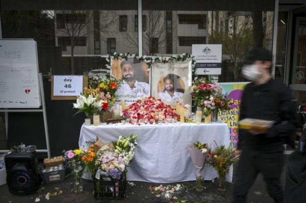 A protest outside the Department of Home Affairs Office in Docklands on Thursday, with photos of asylum seeker Mano Yogalingam, who died from self-immolation.