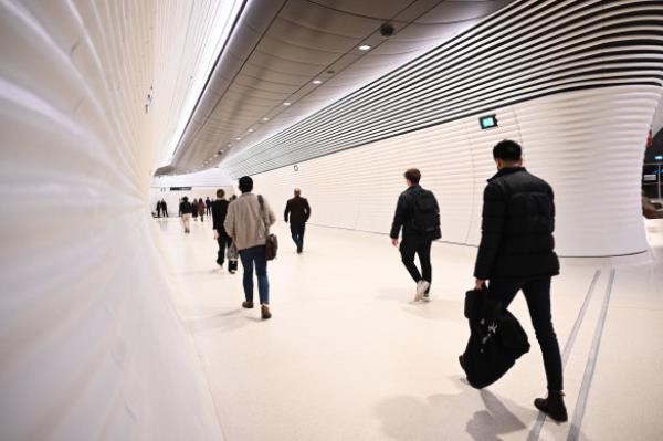 Commuters arrive at Gadigal Station on the first day of the opening of the Metro M1 line.