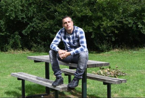 Anthony Lyman sitting on a park table