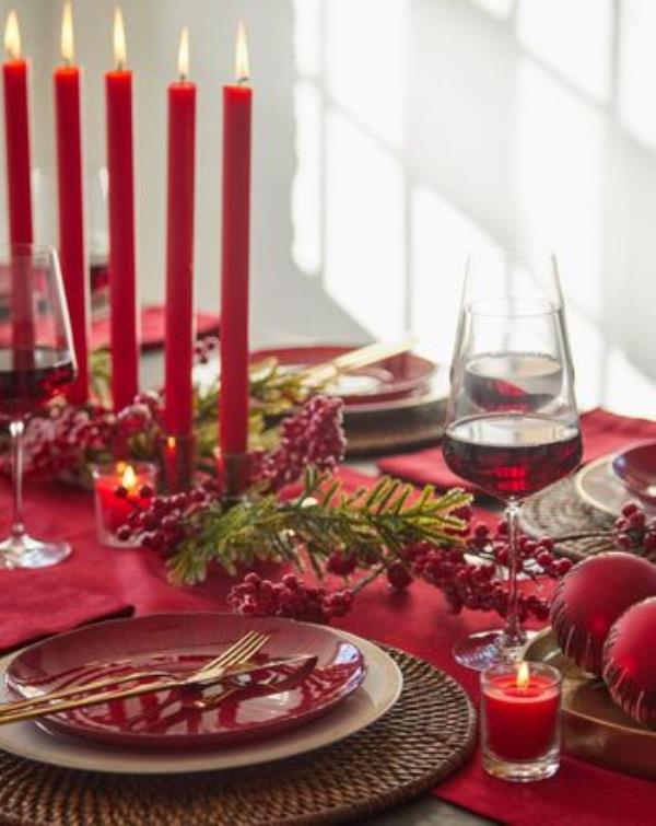Red-themed tablescape: Gold cutlery set, 59.95, me<em></em>tallic angle plate, 9.95, dinner plate, 9.95, seven-taper holder, antique gold, 49, wine glasses, set of six, 44.95, jacquard runner, 24.95, all Meadows & Byrne. 