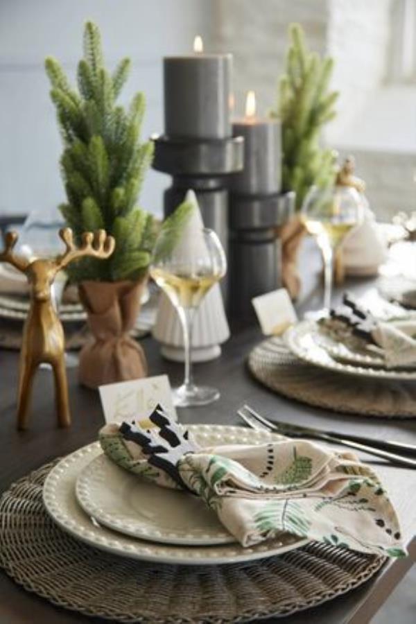 Meadows and Byrne tablescape: Leaf-print napkin set, 29, Fantasy dinner plate, 19, salad plate, 15, rattan placemat, 5.95, napkin rings set of four, 17.95, Do<em></em>nner gold reindeer, 22, Holden candle holder, black, small, 25, Holden candle holder, black, large, 29, Chef & Sommelier Krysta white wine glass, set of six, 55. 