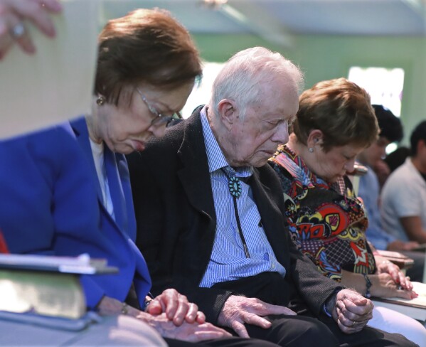 President Jimmy Carter and Rosalynn Carter bow their heads in prayer with members and visitors during the worship service at Maranatha Baptist Church less than a mo<em></em>nth after the 39th U.S. president and Plains native fell breaking his hip, on June 9, 2019, in Plains, Ga. (Curtis Compton/Atlanta Journal-Co<em></em>nstitution via AP)