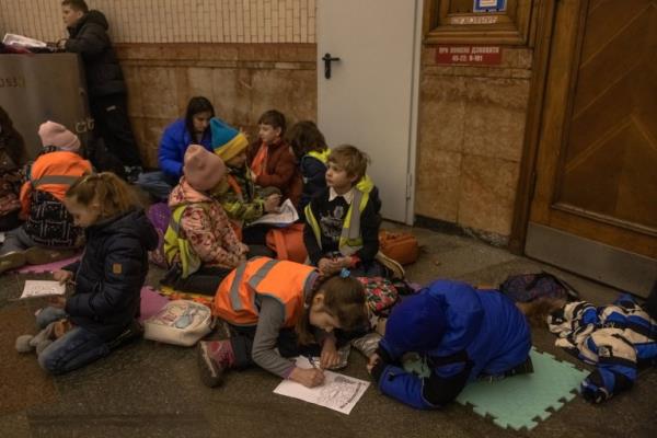 KYIV, UKRAINE - MARCH 20: Schoolchildren attend a Ukrainian language class while sheltering with their teachers in a metro station during an air raid a<em></em>lert on March 20, 2023 in Kyiv, Ukraine. As the large-scale war with Russia entered its second year, the fiercest fighting was co<em></em>ncentrated in the east and south, but residents of Kyiv and other Ukrainian cities live with the co<em></em>nstant threat of aerial attack. (Photo by Roman Pilipey/Getty Images)