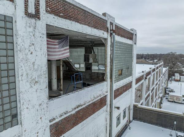 A U.S. flag is draped near a missing window in the former Libby, McNeill & Libby canning plant on Western Avenue in Blue Island, which opened in 1918 and canned locally grown produce for shipment around the world, including to U.S. military personnel.