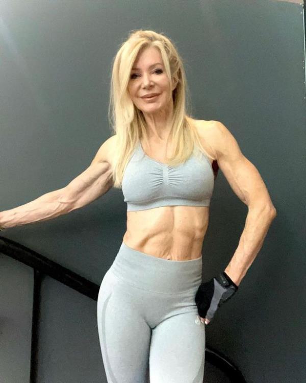 Lesley Maxwell poses in blue gym wear