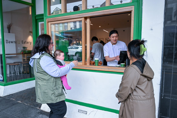 Dawn Eatery co-owner John Woo serving customers on Christmas Day. 